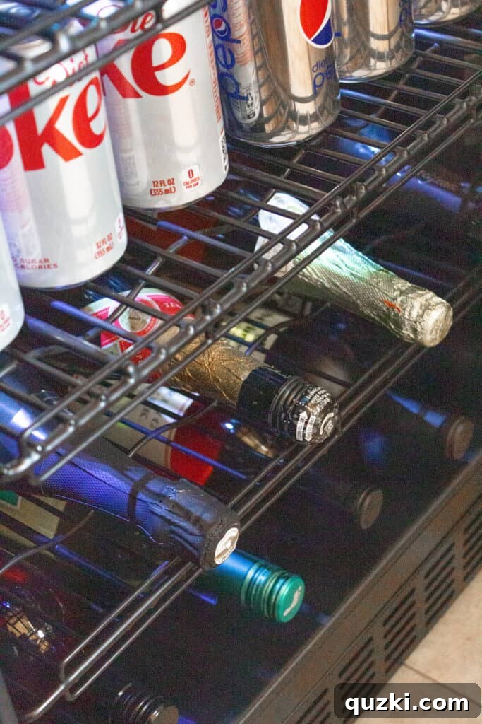 Inside view of Newair FlipShelf fridge showing flexible shelving for wine bottles and soda cans.