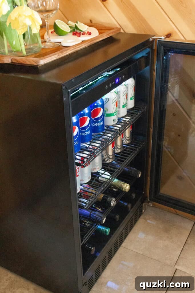 Newair beverage fridge filled with various chilled drinks, highlighting its capacity and organization.