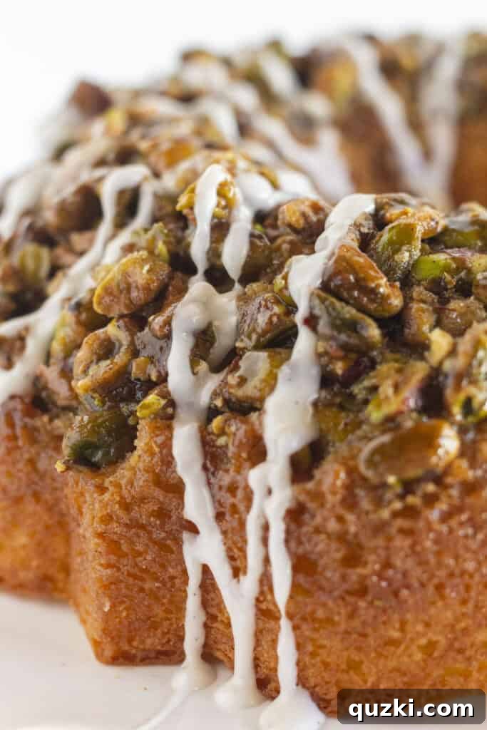 45 Simple & Stunning Cake Mix Bundt Cake Recipes 28 A close up of pistachio bundt cake with vanilla glaze.