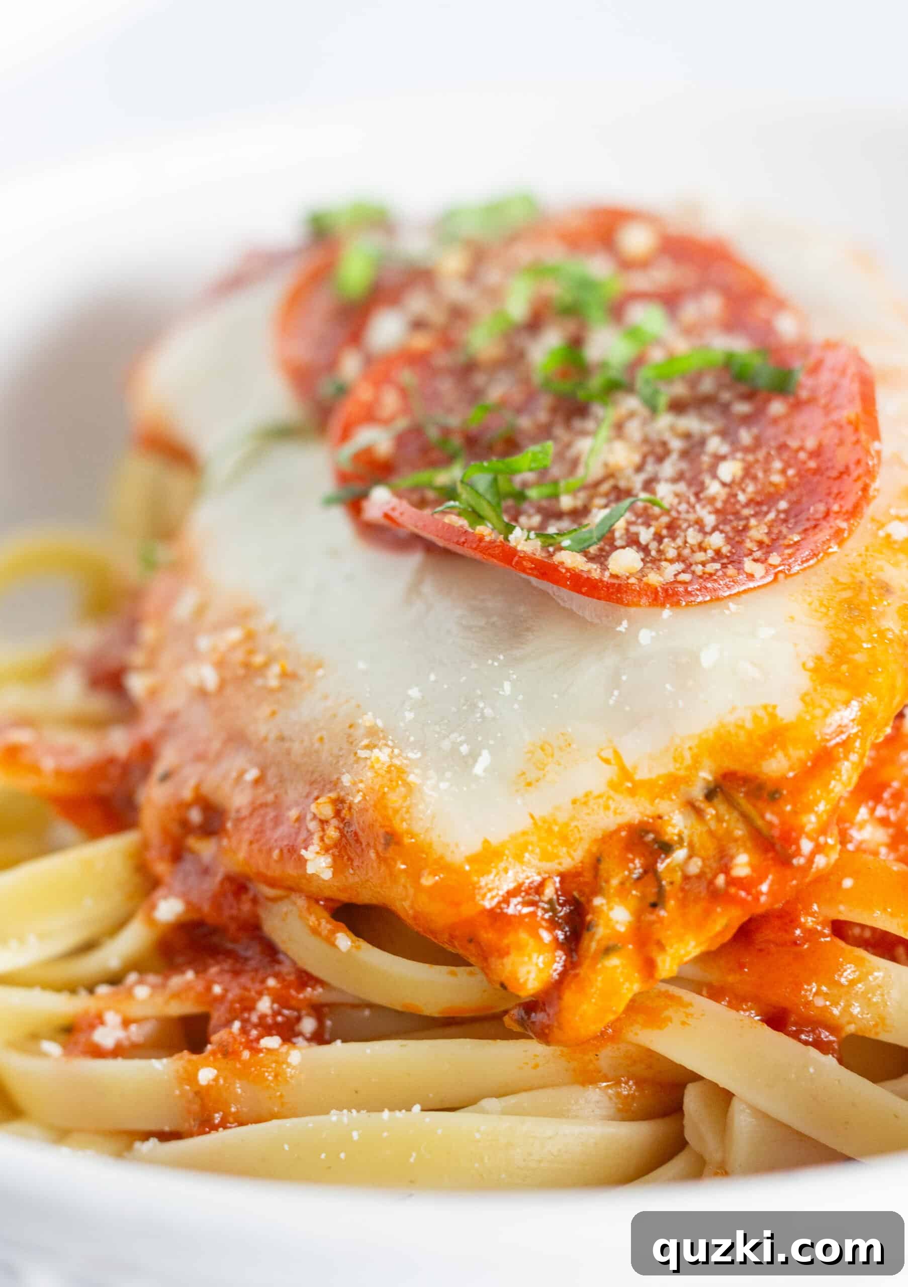 Pepperoni pizza skillet on a bed of pasta.