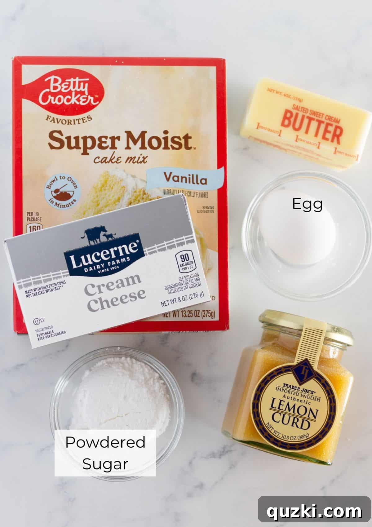 Zesty Lemon Curd Cookies 3 All the necessary ingredients laid out for preparing lemon curd cookies, including cake mix, cream cheese, butter, egg, lemon curd, and powdered sugar.