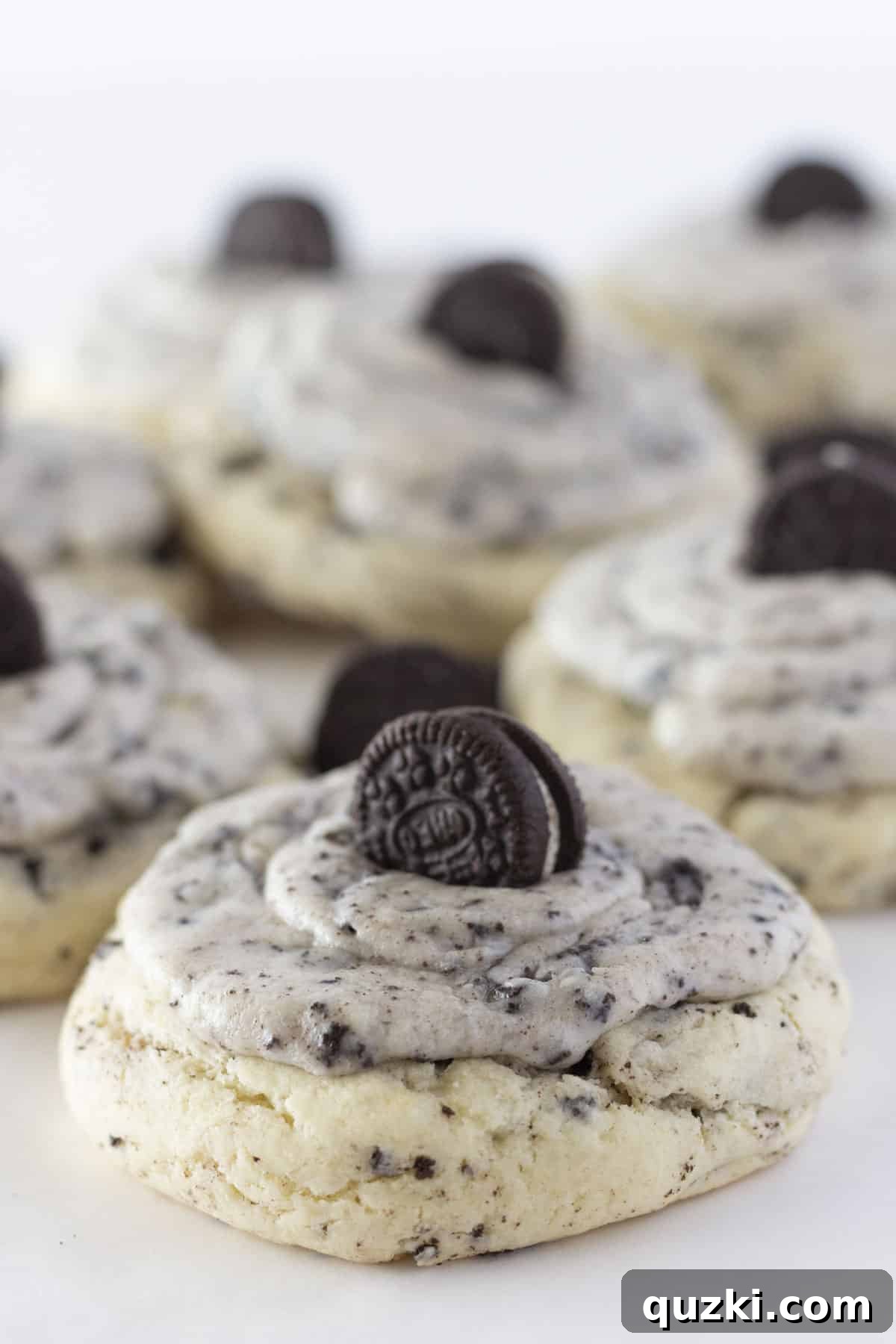 Large Cookies and Cream cookies displayed on a elegant white serving tray, each topped with a small mini Oreo cookie, highlighting their delicious texture and presentation.