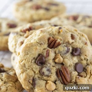 Stacked cowboy cookies on a wire rack.