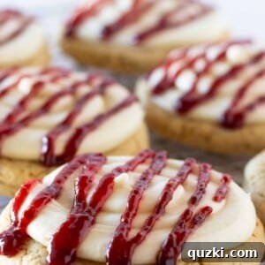 A delectable Raspberry Cheesecake Cookie with perfect frosting and raspberry swirl.