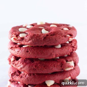 A large, soft Crumbl-style Red Velvet White Chocolate Chip Cookie