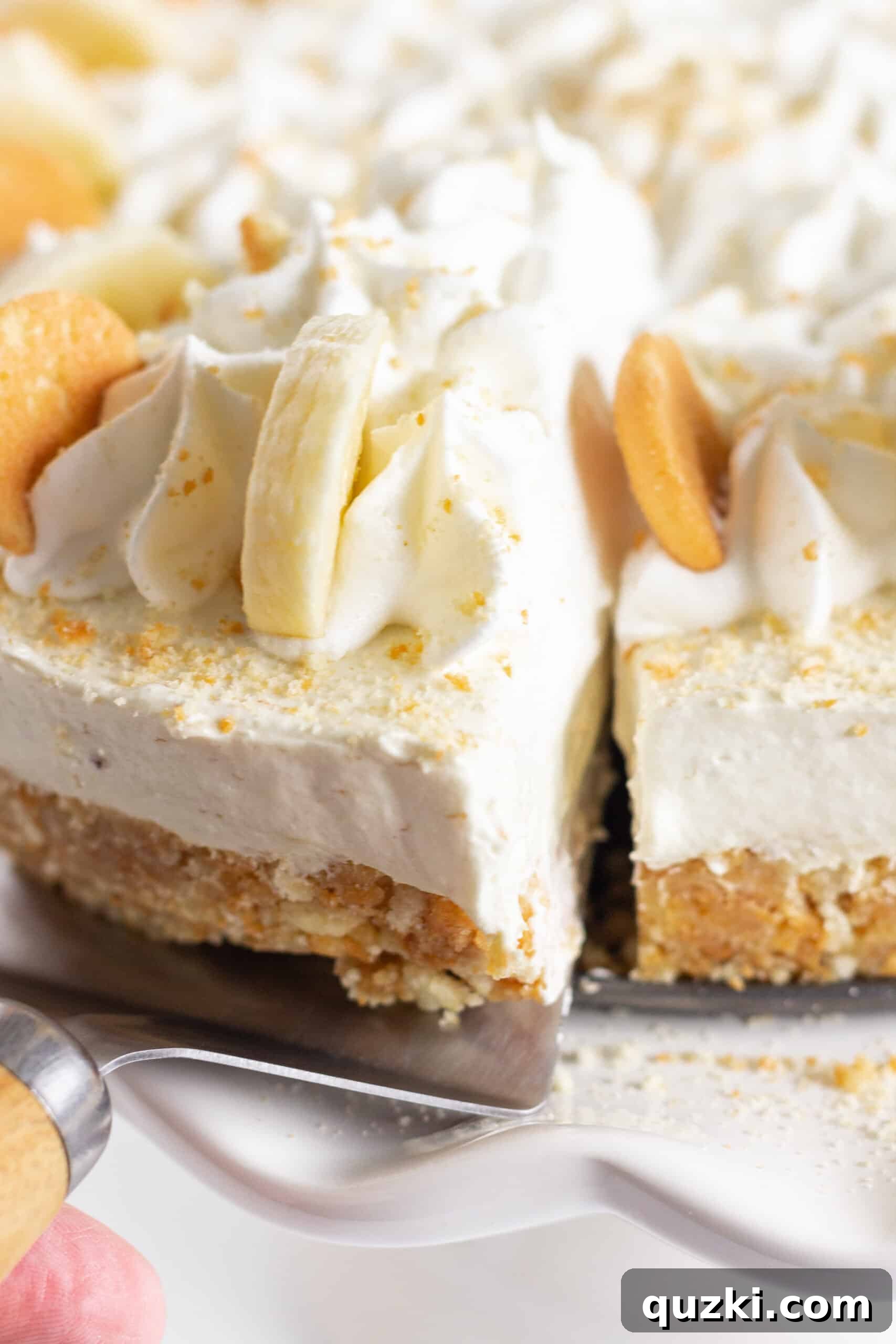 Serving a slice from the banana pudding no bake cheesecake.