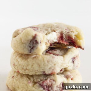 Three strawberry cream cheese cookies stacked on each other.