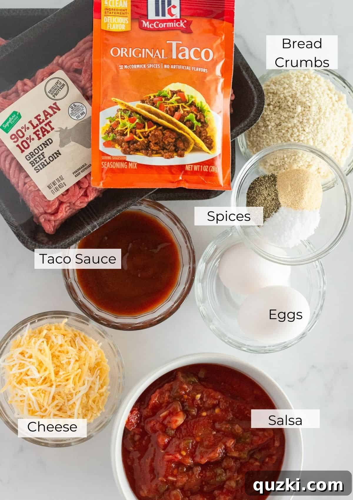 The individual ingredients needed to make a taco meatloaf laid out on a table.