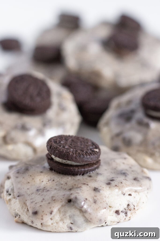 A stack of perfectly glazed Oreo Sheet Cake Cookies on a rustic wooden surface, highlighting their soft texture and rich glaze, a popular recipe from Practically Homemade