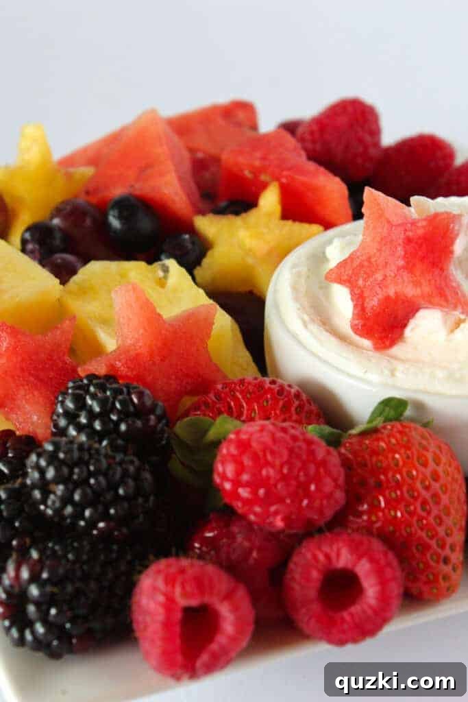 Patriotic 4th of July Fruit Tray with star-shaped fruit cutouts and a creamy 3-ingredient cheesecake dip
