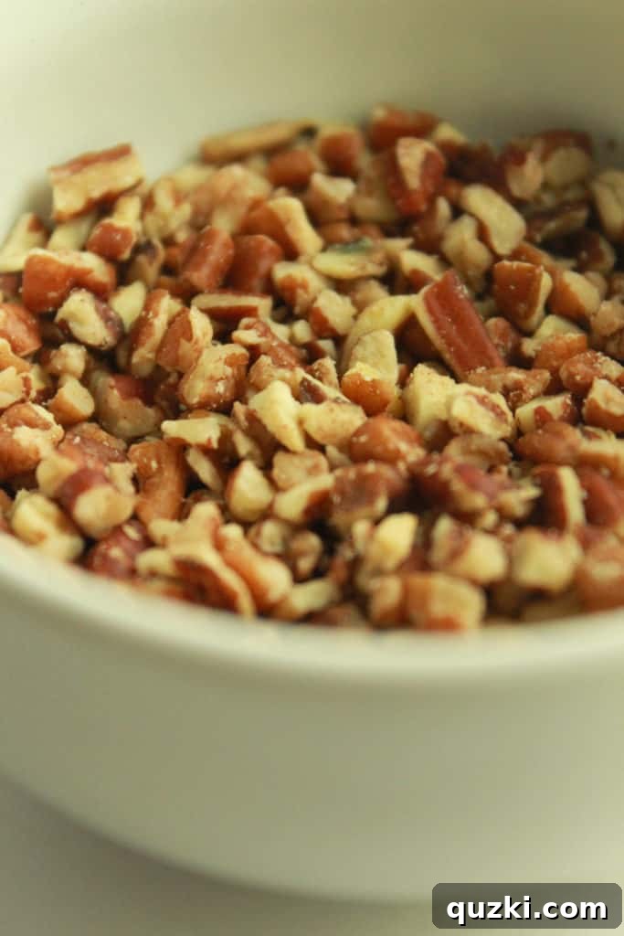 Maple Pecan Bliss Scones 5 Adding chopped pecans to the scone dough mixture.