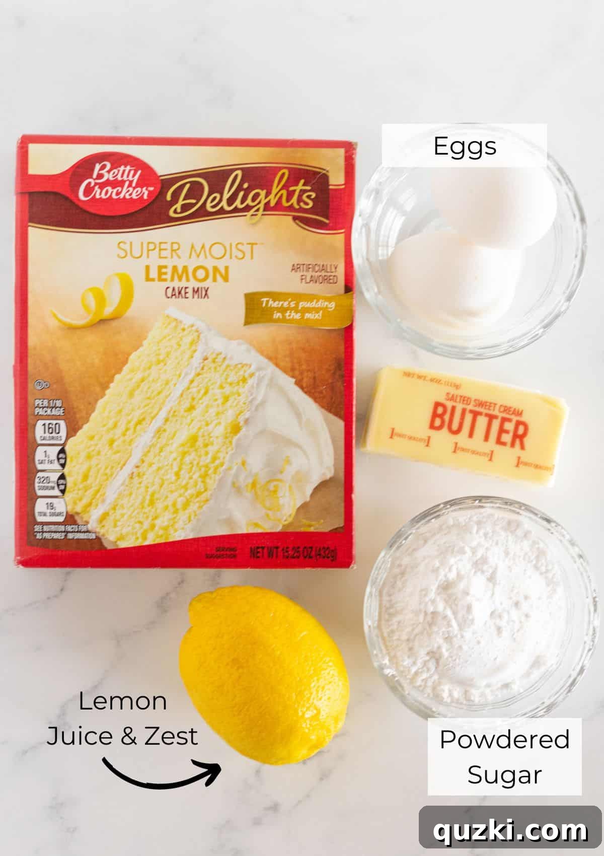 A flat lay of ingredients for lemon cake mix cookie bars including a box of lemon cake mix, eggs, butter, lemons, and powdered sugar.