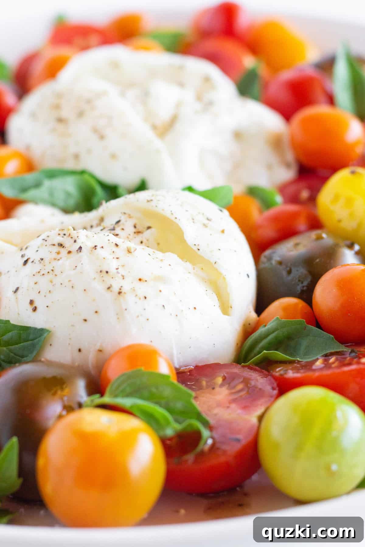 Luscious Burrata Caprese 2 Close-up of a beautifully arranged Burrata Caprese salad with fresh tomatoes, basil, and creamy burrata cheese, perfect for a summer appetizer.
