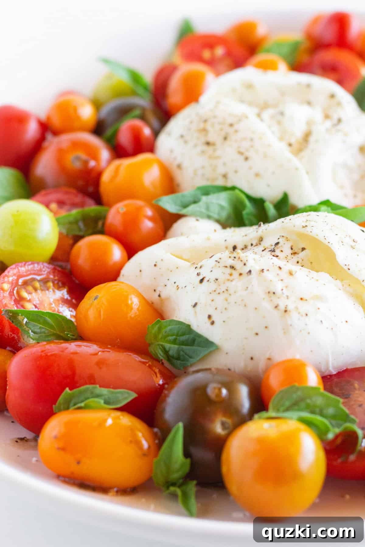 Luscious Burrata Caprese 5 Burrata Caprese salad with assorted tomatoes, fresh basil, and a generous drizzle of balsamic glaze, styled for a gourmet food blog.