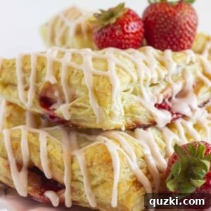 Fresh strawberry turnovers on a pink cake plate.