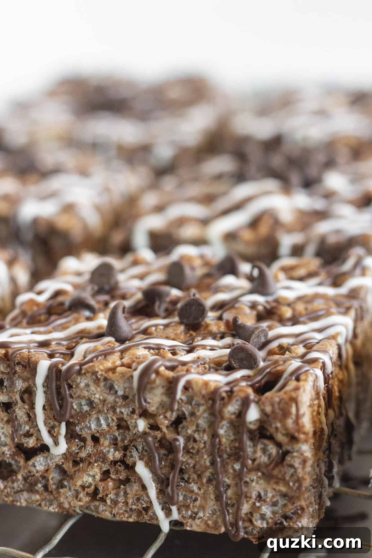 No-Bake Chocolate Crispy Squares 7 A close up photo showing the chocolate drizzle on top of each bar.