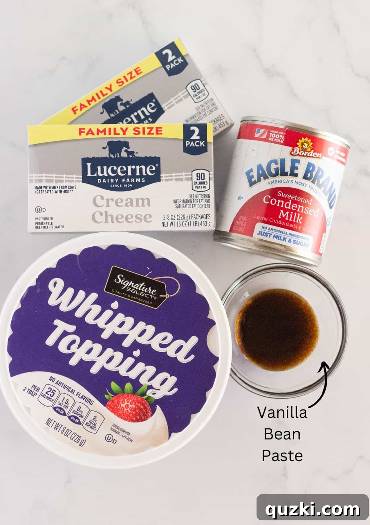 All the essential ingredients neatly laid out on a clean countertop, carefully arranged and ready to be used for making a delicious vanilla no bake cheesecake.