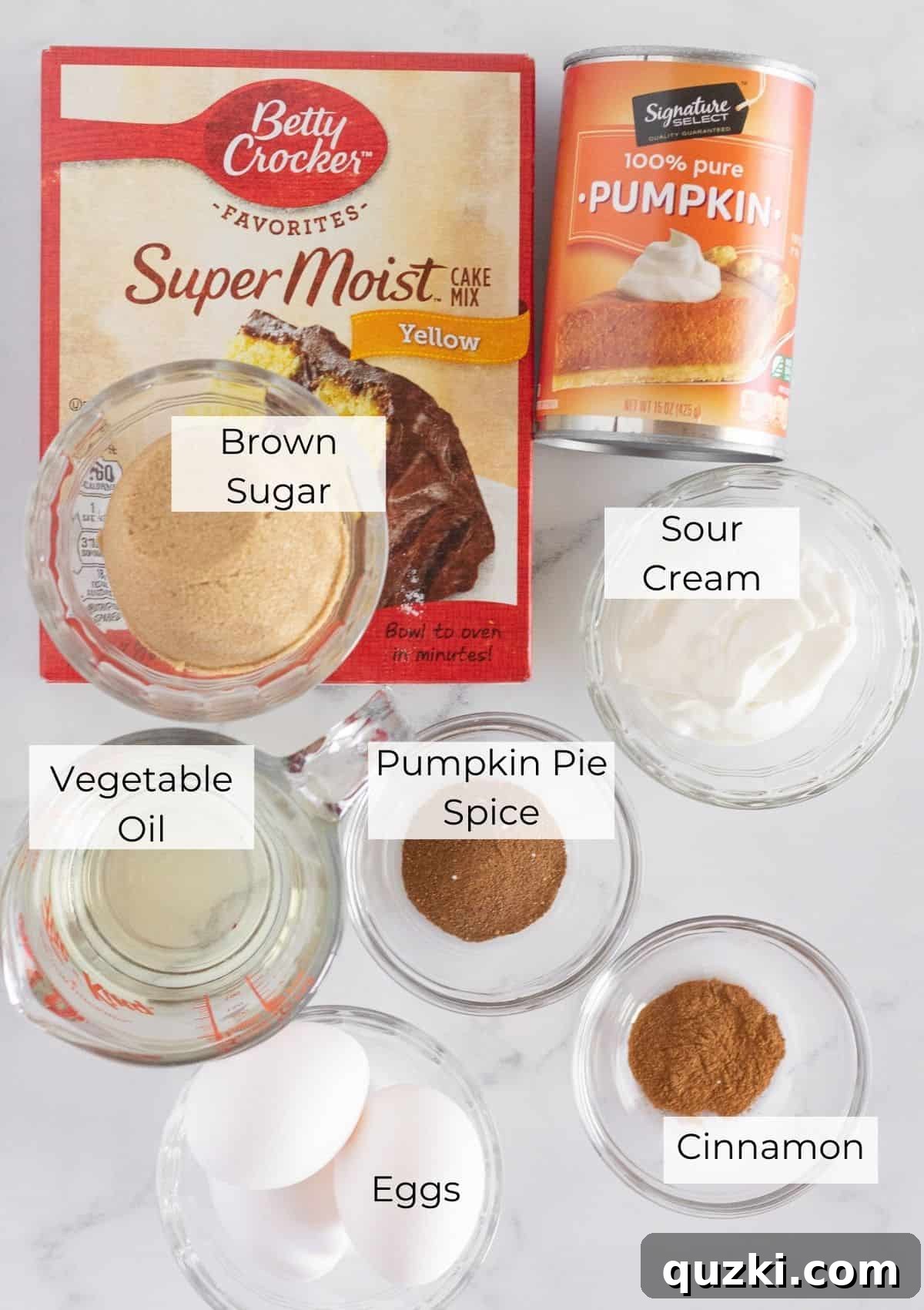 Cake Mix Shortcut Pumpkin Spice Loaf 3 A display of the essential ingredients needed to make pumpkin bread with a cake mix, neatly arranged.