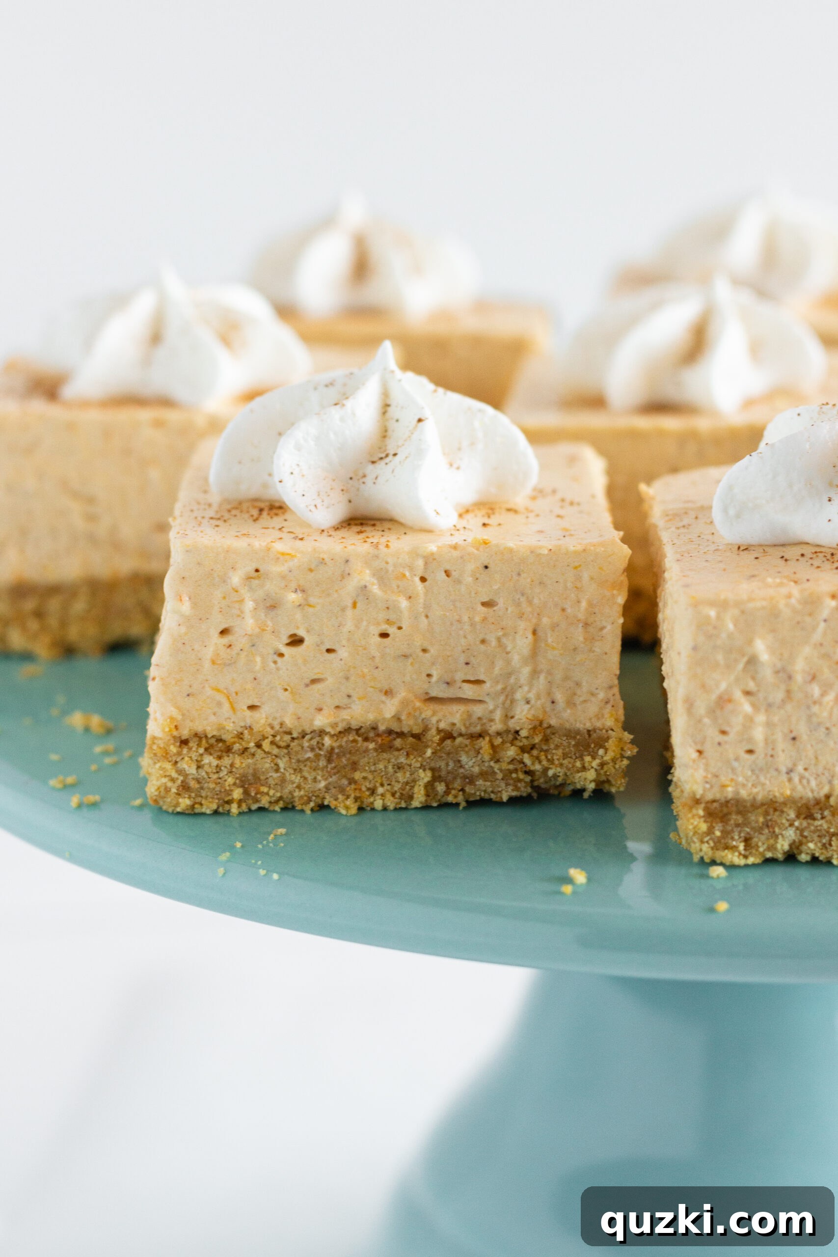 Close-up of creamy No Bake Pumpkin Cheesecake Bars ready to be cut, by Top US dessert blog Practically Homemade