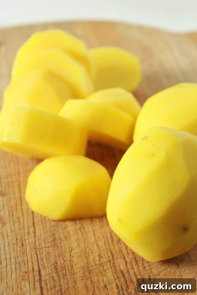 Melt-in-Your-Mouth Roasted Potatoes 3 Peeled and uniformly sliced Yukon Gold potatoes, arranged for the next step in the melting potatoes recipe.