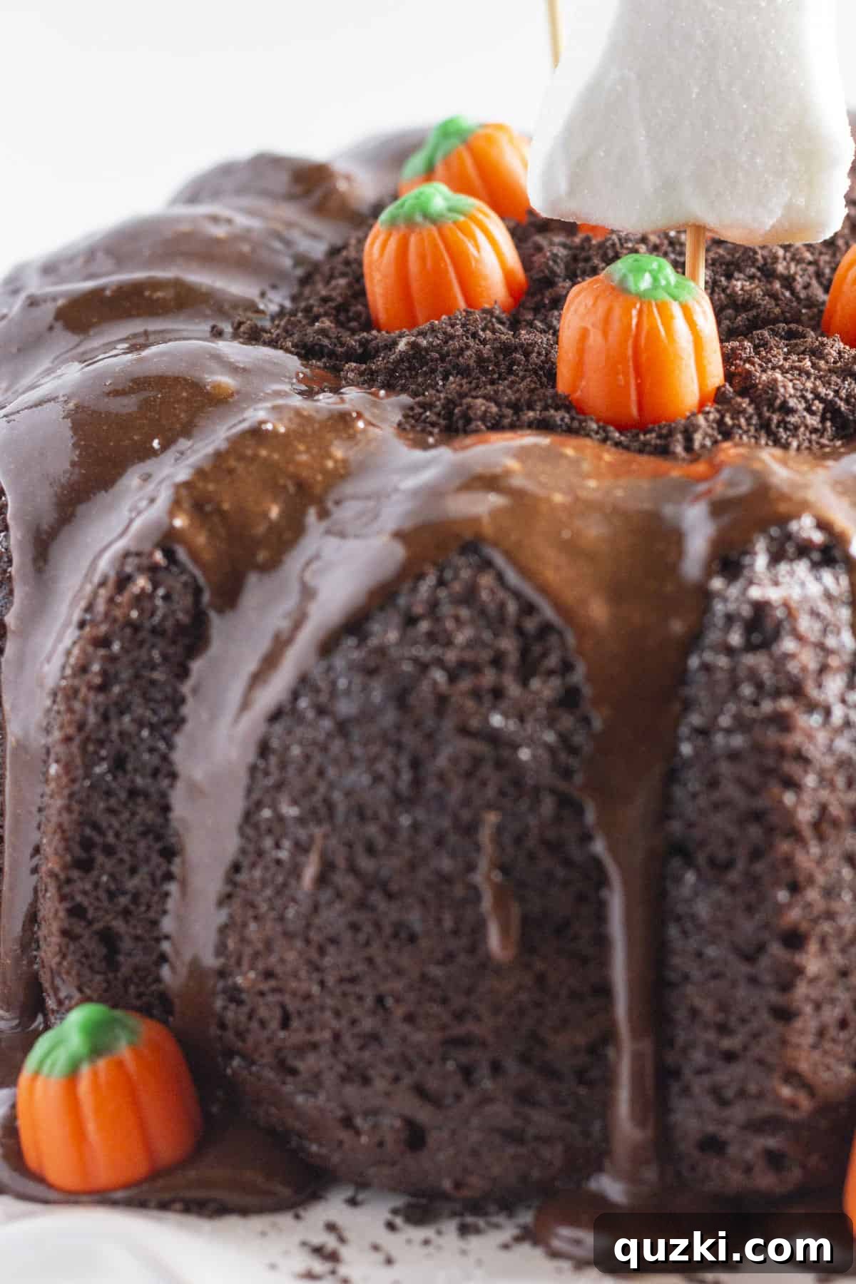 An inviting, close-up photo showcasing all the essential ingredients laid out for decorating a festive Halloween Bundt Cake, including frosting, candies, and cookie crumbs.