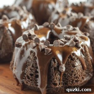 Mini Chocolate Bundt Cakes on a wood cake plate.