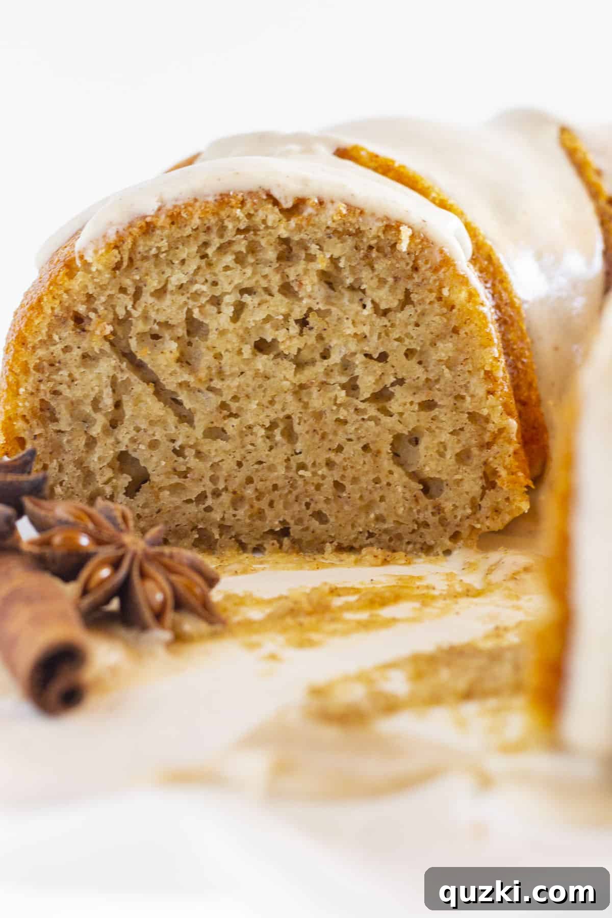 A close-up view of the inside of a moist spice bundt cake, showing its tender crumb and rich texture.