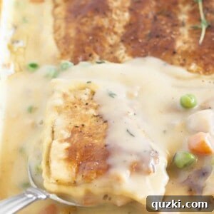 Serving turkey pot pie with puff pastry, fresh out of the oven.