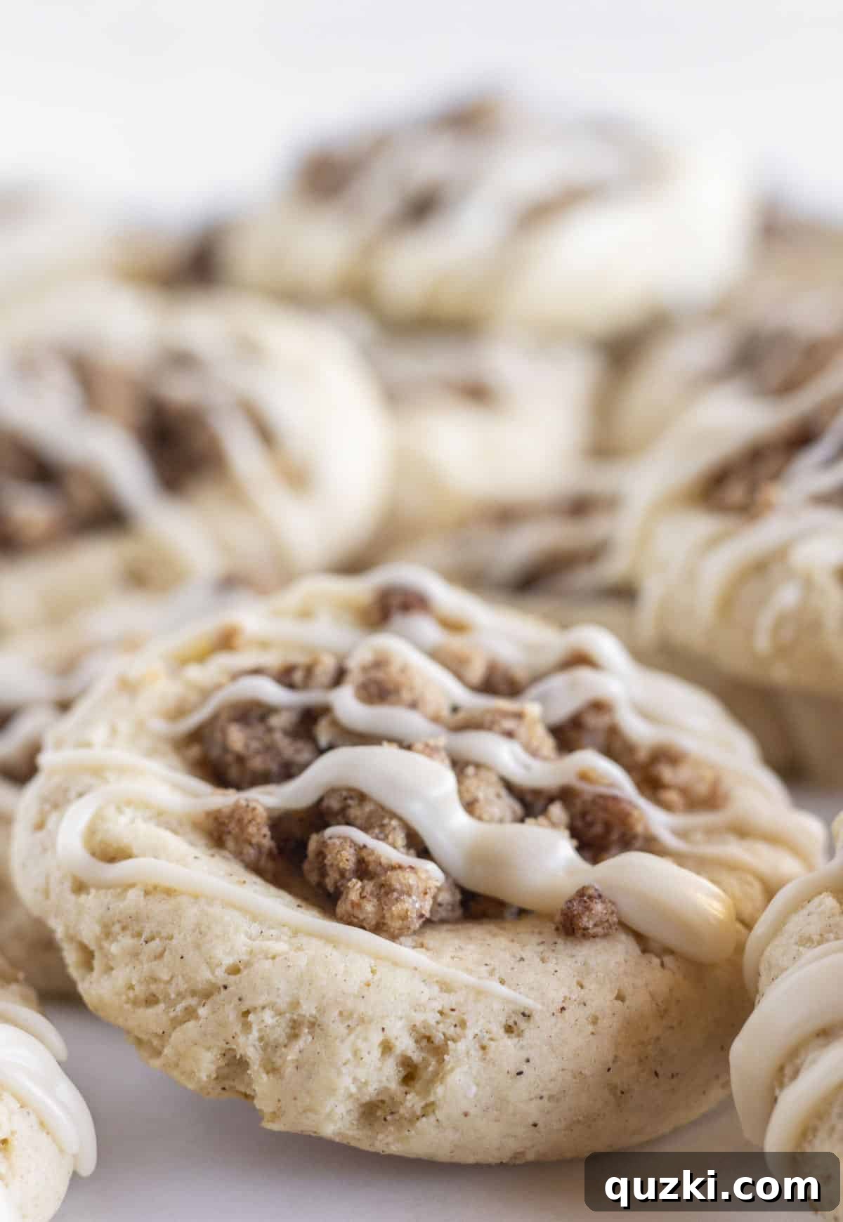 20 Festive Cake Mix Cookies Made Easy 20 A rustic tray showcasing a collection of warm cinnamon coffee cake cookies, each delicately drizzled with glaze, perfect for a cozy moment.