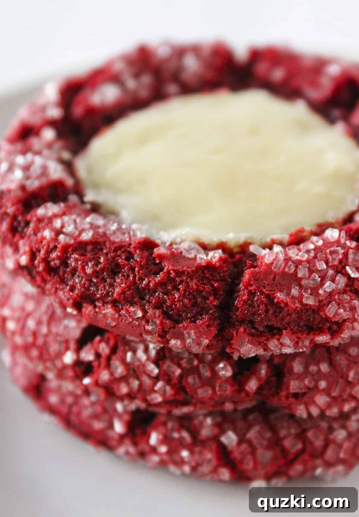 20 Festive Cake Mix Cookies Made Easy 21 An enticing stack of three delicious red velvet cheesecake cookies, showcasing their vibrant color and creamy cheesecake layer.