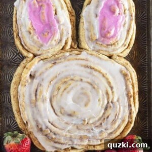 A large cinnamon roll bunny made with refrigerated cinnamon rolls, topped with white and pink frosting, perfect for an Easter breakfast.