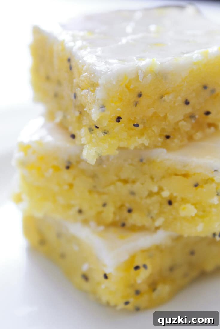 Tangy and sweet glazed lemon poppy seed bars with a brownie-like texture, a bright Mother's Day treat.
