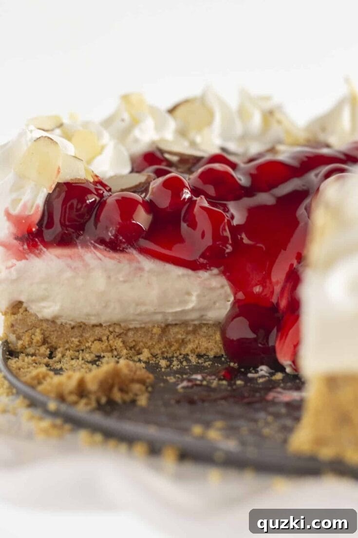 Easy no-bake cherry cheesecake with a graham cracker crust and smooth creamy filling, topped with cherry pie filling.