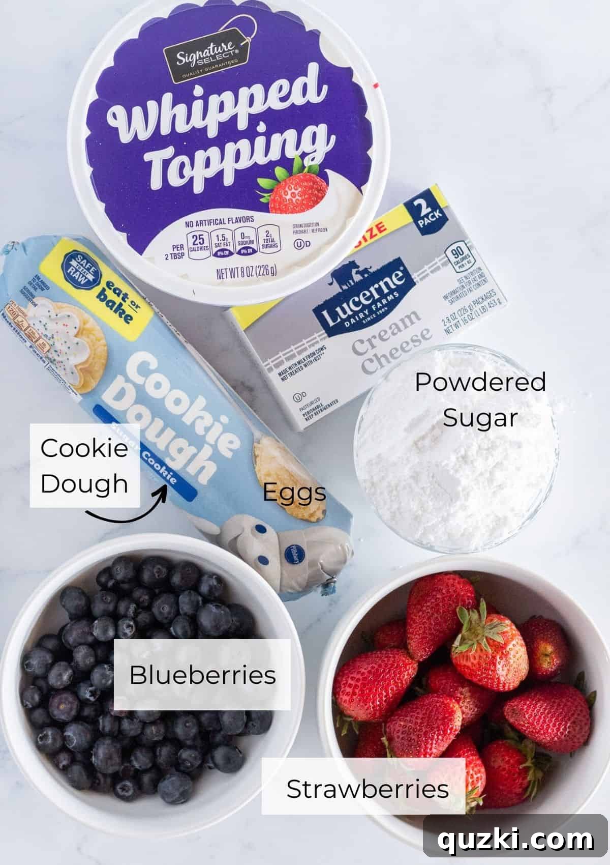 Star-Spangled Fruit Pizza Treat 3 A photo of the simple, essential ingredients needed for this delicious flag fruit pizza: cookie dough, cream cheese, powdered sugar, whipped topping, strawberries, and blueberries.