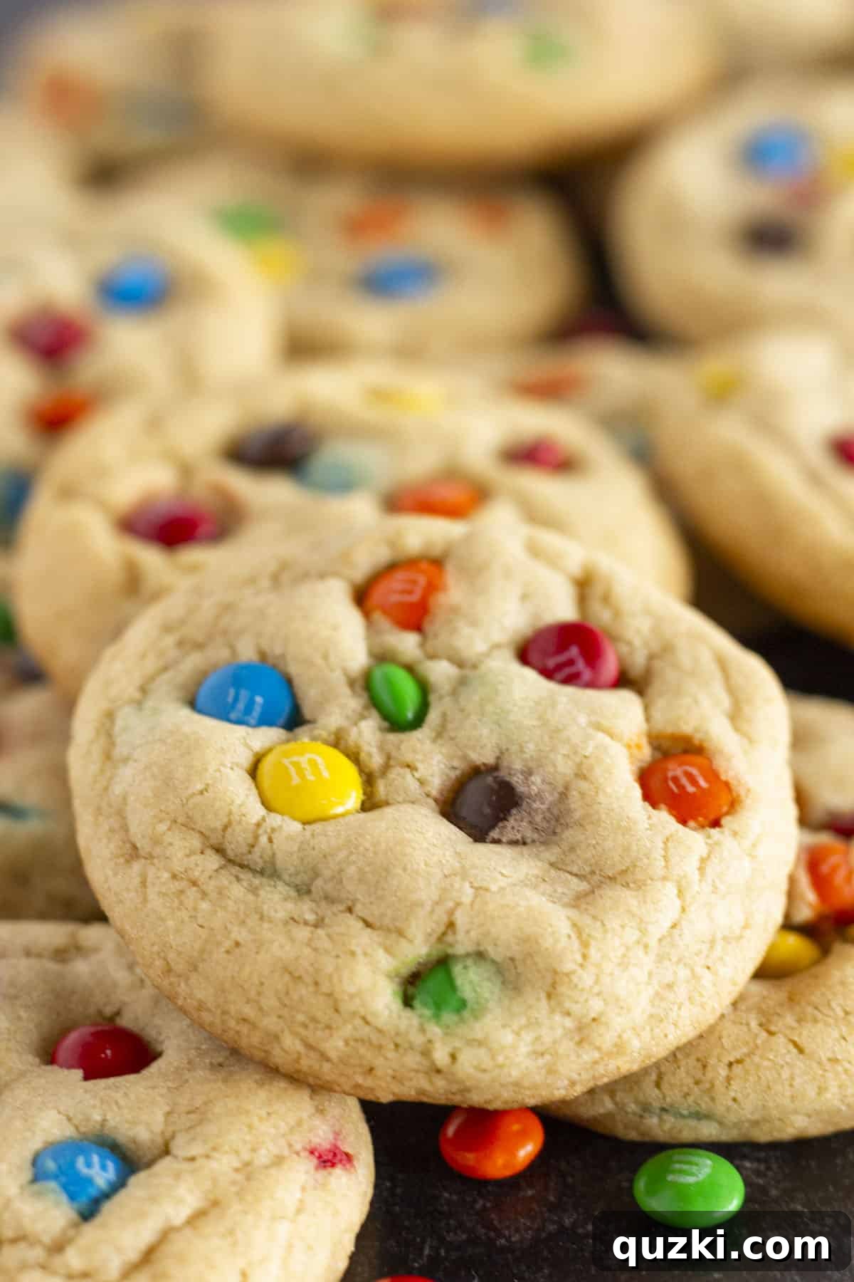 Irresistible Mini M&M Cookies 7 A close up of a perfectly chewy Mini M&M Cookie, showing the soft interior and melted M&M's.