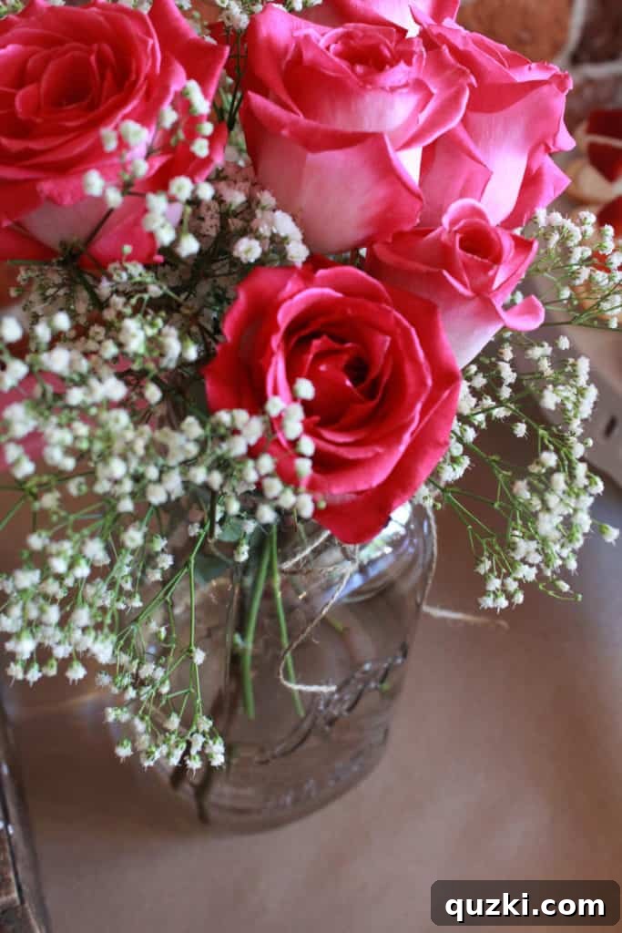 Host a Showstopping Dessert Buffet 13 Beautiful mason jar flower arrangement with fresh roses, a simple yet elegant decoration for any party table.
