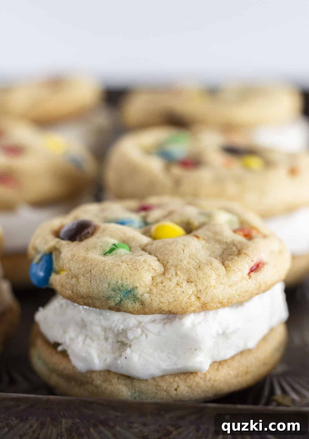 M&M Cookie Ice Cream Sandwiches From Scratch 7 A large tray filled with perfectly assembled M&M ice cream sandwich cookies, showcasing their uniform size and inviting appearance.