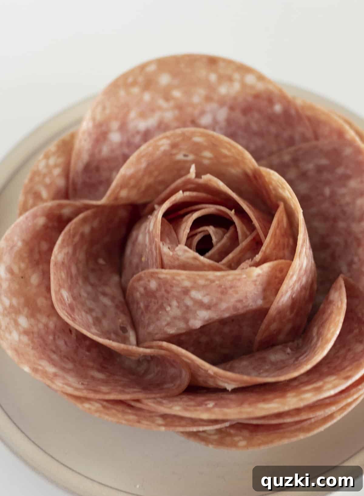 A close up of a large salami rose.