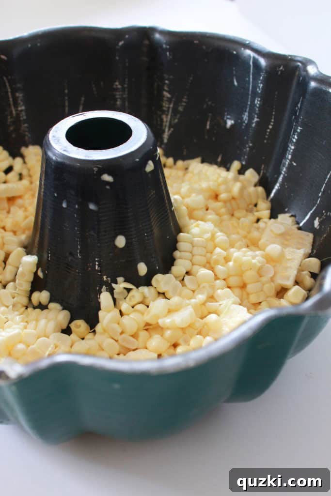 The Bundt pan hack in action, with corn kernels neatly collected in the pan after being cut from the cob.
