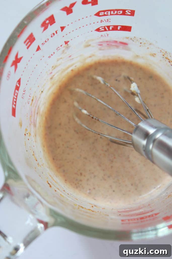 Creamy, zesty dressing for Mexican Street Corn, showing its smooth consistency before being mixed with the corn.