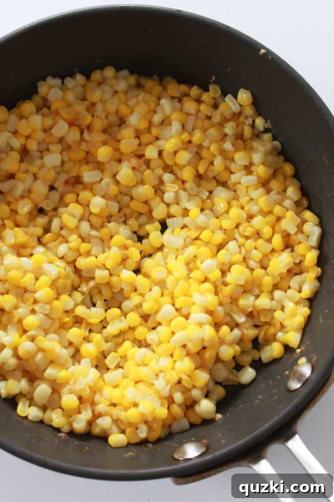 Close-up of sautéed corn kernels in a skillet, showcasing the delicious golden-brown char.