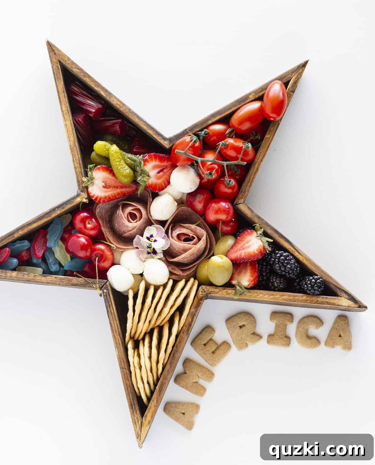 Star-Spangled Fourth of July Charcuterie 2 A beautifully arranged 4th of July charcuterie board on a star-shaped tray, featuring red, white, and blue themed foods.