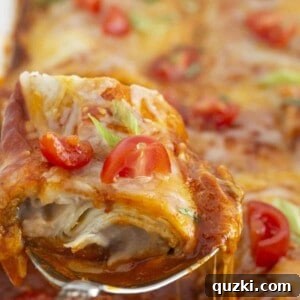 Serving frozen burrito casserole with a spoon, highlighting the melted cheese and sauce.