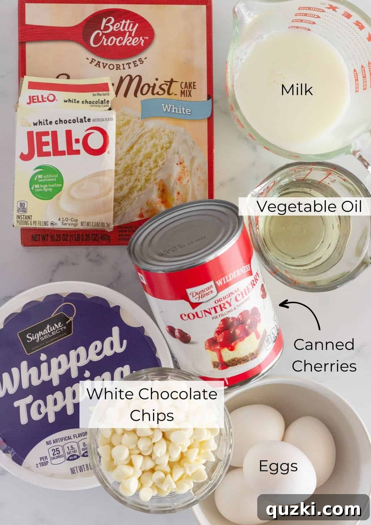 Effortless White Forest Indulgence 3 The essential ingredients laid out for making a delicious white forest cake, including cake mix, pudding mix, eggs, milk, vegetable oil, white chocolate chips, cherry pie filling, and whipped topping.