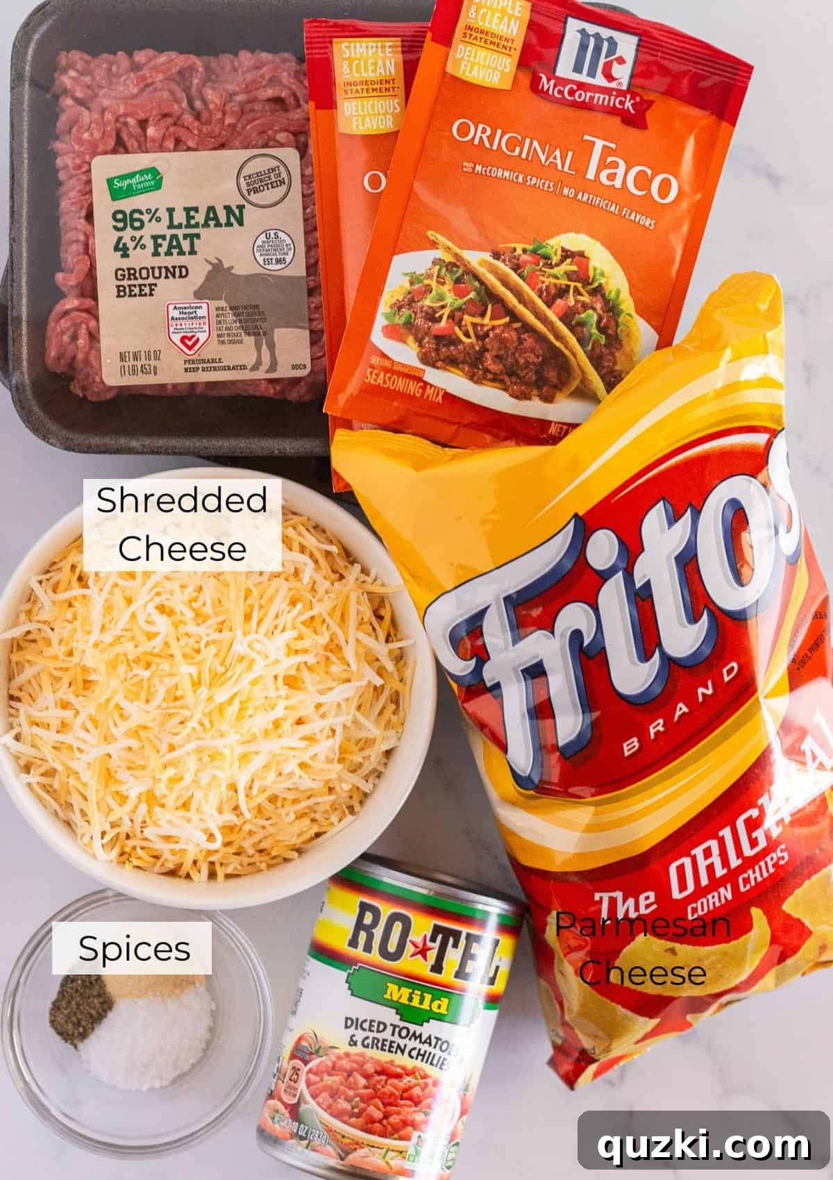 A selection of fresh ingredients laid out for making walking taco casserole, including ground beef, Rotel, taco seasoning, cheese, and a bag of Fritos.