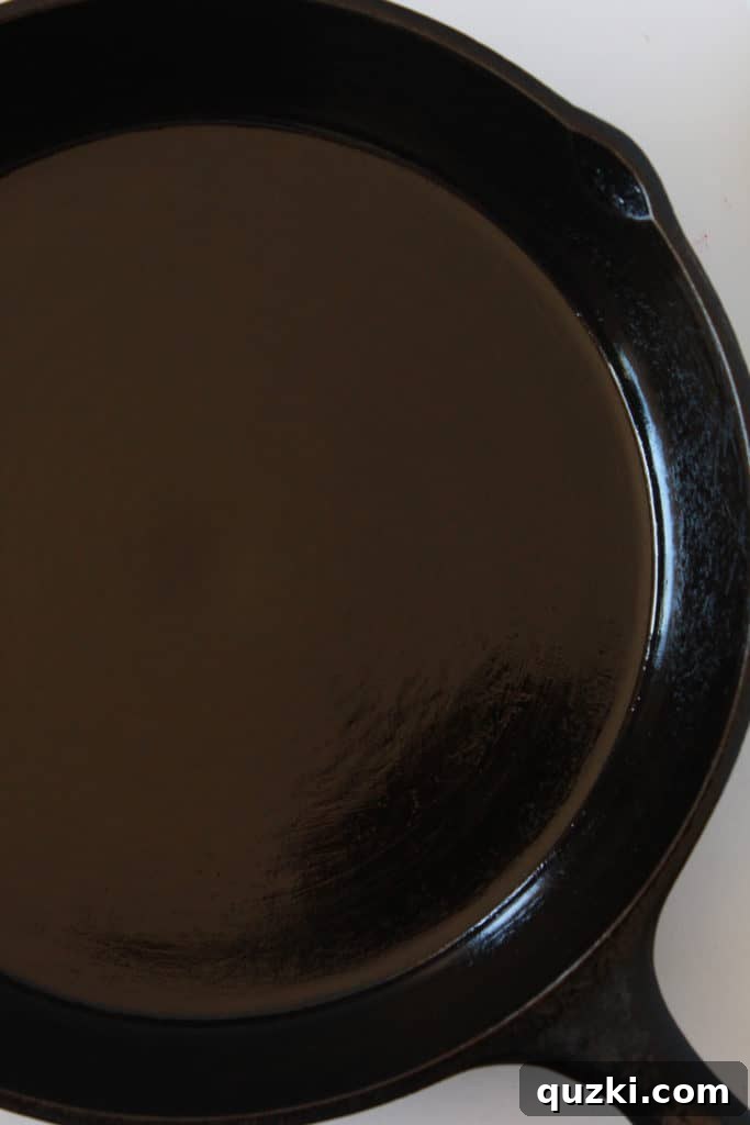 Unlock the Full Potential of Your Cast Iron 5 Using a paper towel to wipe a thin, even layer of vegetable oil across the entire surface of the cast iron skillet.