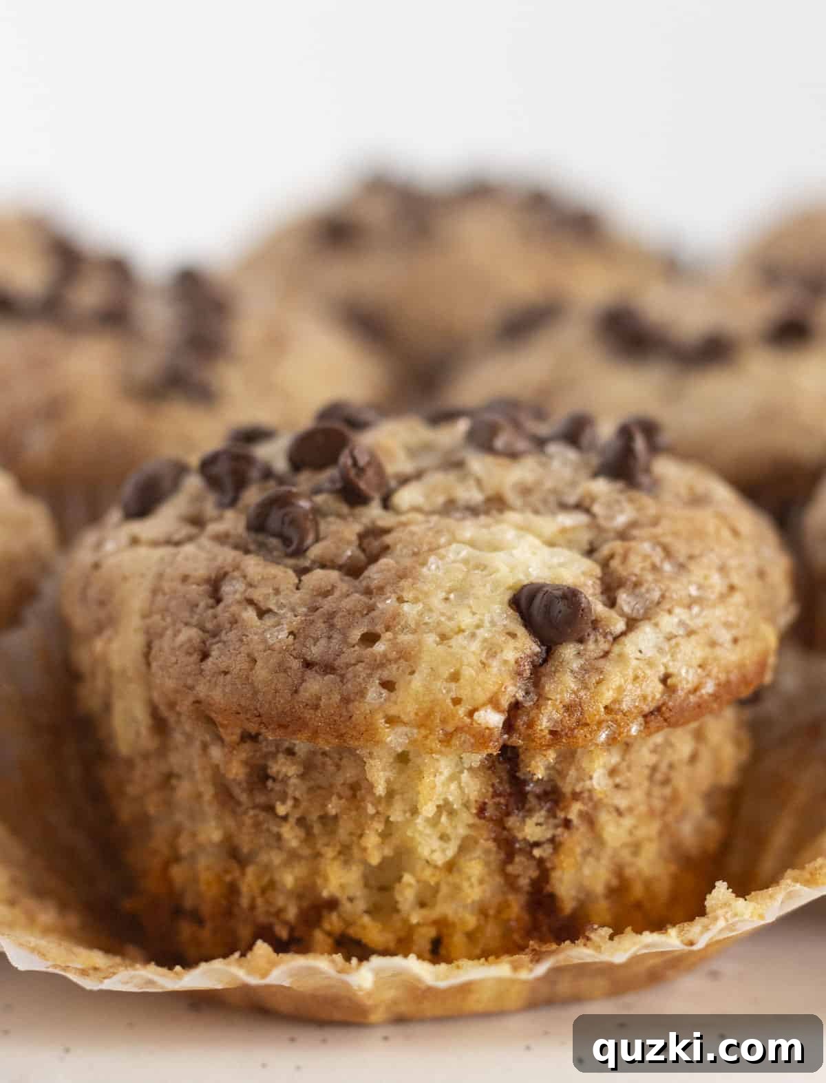 A Nutella swirled muffin with the wrapper off and ready to eat, showcasing its beautiful swirls and golden-brown top.