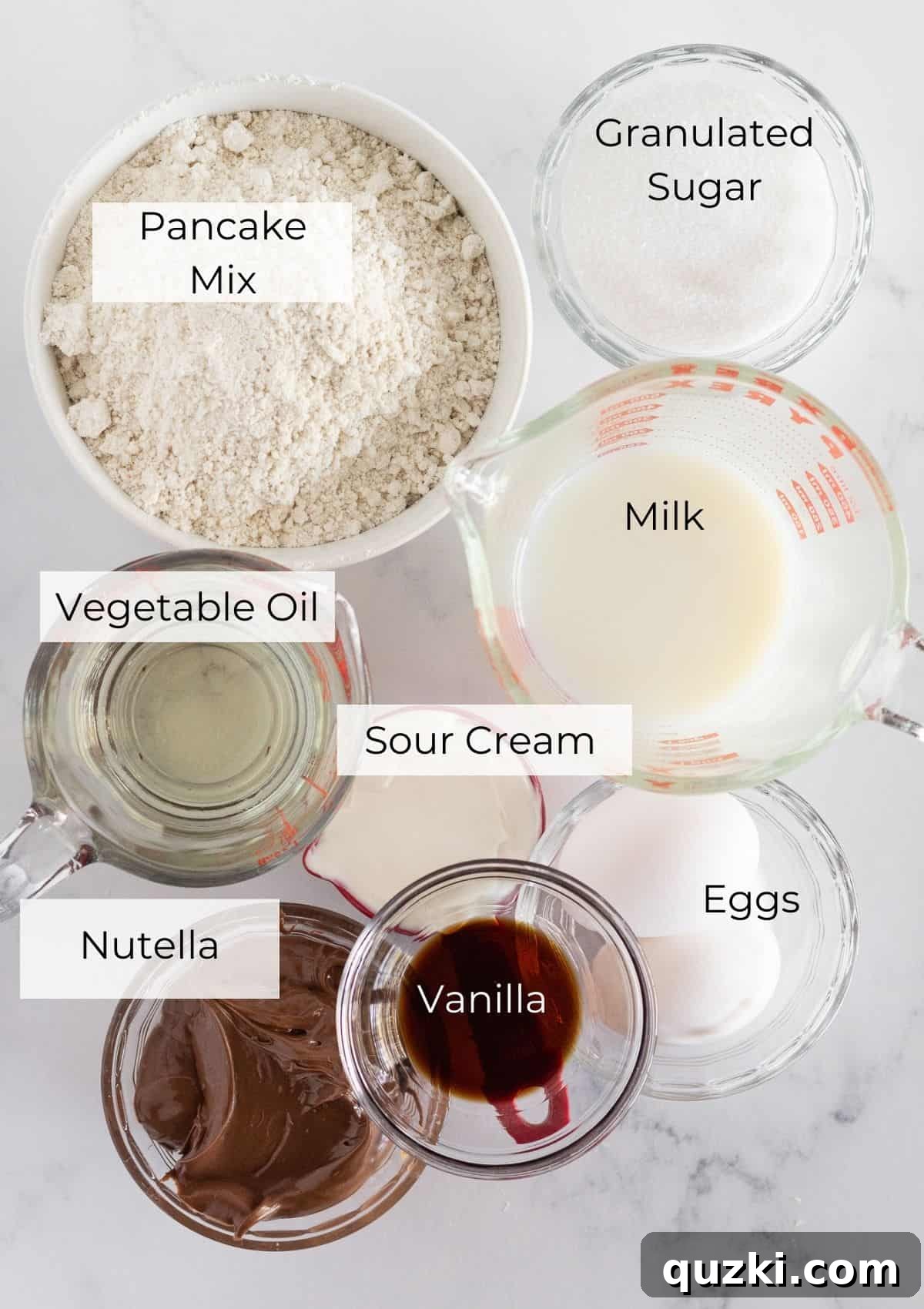 The ingredients needed to make Nutella Muffins laid out on a table.