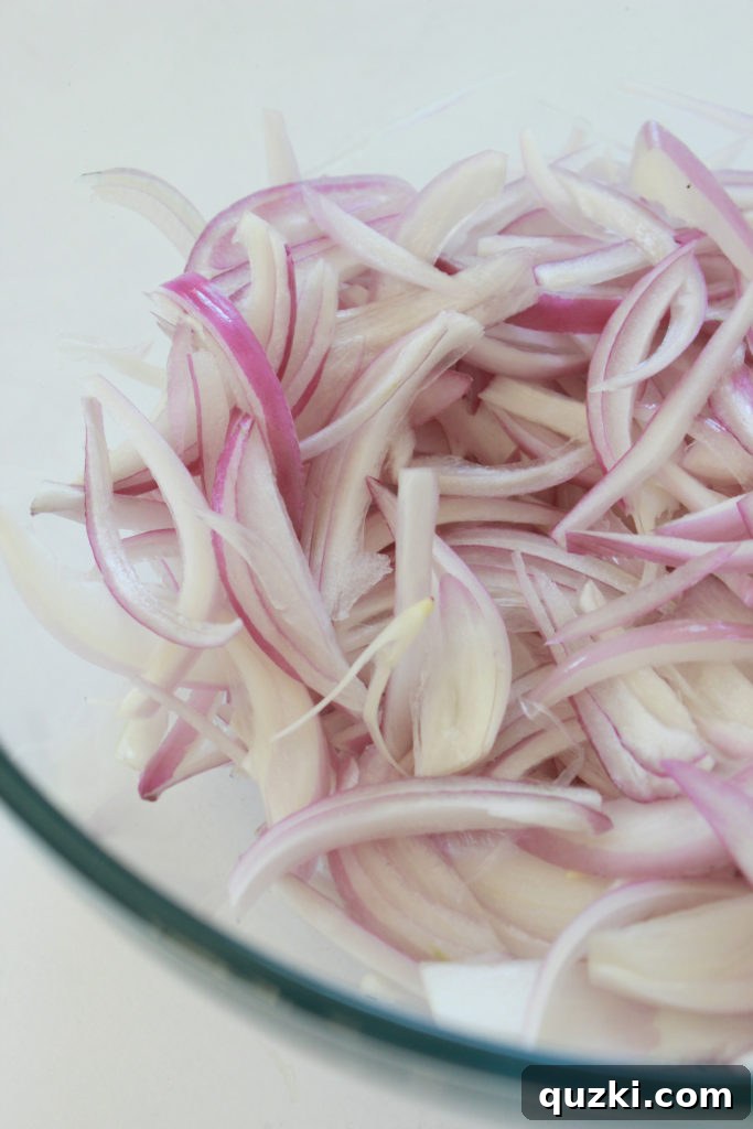 Tangy Shallot Gems 4 Thinly sliced shallots prepared in a glass bowl