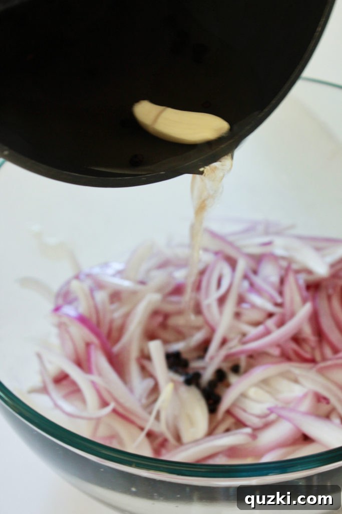 Tangy Shallot Gems 5 Hot pickling liquid being poured over sliced shallots